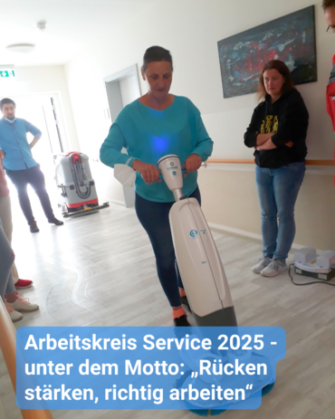 Eine Frau benutzt eine Bodenreinigungsmaschine, während andere zusehen. Text: 'Arbeitskreis Service 2025 - unter dem Motto: „Rücken stärken, richtig arbeiten“'.